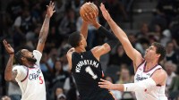 San Antonio Spurs forward Victor Wembanyama (1) shoots while defended by Los Angeles Clippers center Brook Lopez (11) and guard Derrick Jones Jr. (5) during the first half at Frost Bank Center. Mandatory Credit: Scott Wachter-Imagn Images