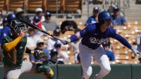 Los Angeles Dodgers second baseman Hyeseong Kim (6) hits against the Athletics in the first inning at Camelback Ranch-Glendale