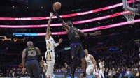 Los Angeles Lakers center Deandre Ayton (5) and forward LeBron James (23) and New Orleans Pelicans guard Dejounte Murray (5) reach for the ball in the first half at Crypto.com Arena.