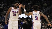 Philadelphia 76ers center Joel Embiid (21) high fives forward Kelly Oubre Jr. (9) during the second quarter against the Milwaukee Bucks at Fiserv Forum.