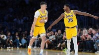 Los Angeles Lakers forward Jake LaRavia (12) celebrates with guard Marcus Smart (36) after a three-point basket in the first half against the Minnesota Timberwolves at Crypto.com Arena.