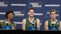 Hawaii Rainbow Wahine guard Dre Bullock (4), left, center Isaac Johnson (20), and forward Harry Rouhliadeff (14) answer questions during a press conference before a practice session ahead of the first round of the men's 2026 NCAA Tournament at Moda Center.