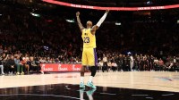 Los Angeles Lakers forward LeBron James (23) celebrates guard Luka Doncic (not shown) after scoring 60 points against the Miami Heat at Kaseya Center.