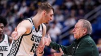 Michigan State center Carson Cooper (15) talks to head coach Tom Izzo after a play against Louisville during the second half of NCAA Tournament Second Round at KeyBank Center in Buffalo on Saturday, March 21, 2026.