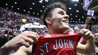 St. John's Red Storm guard Dylan Darling (0) celebrates after defeating the Kansas Jayhawks in the second half during a second round game of the men's 2026 NCAA Tournament at Viejas Arena.