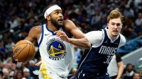 Golden State Warriors guard Moses Moody (4) drives to the basket as Dallas Mavericks forward Cooper Flagg (32) defends during the second half at American Airlines Center.