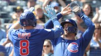 Chicago Cubs second baseman Nico Hoerner (rioht) greets left fielder Ian Happ (8) crossing home plate on a two run home run against the Pittsburgh Pirates during the first inning at PNC Park.