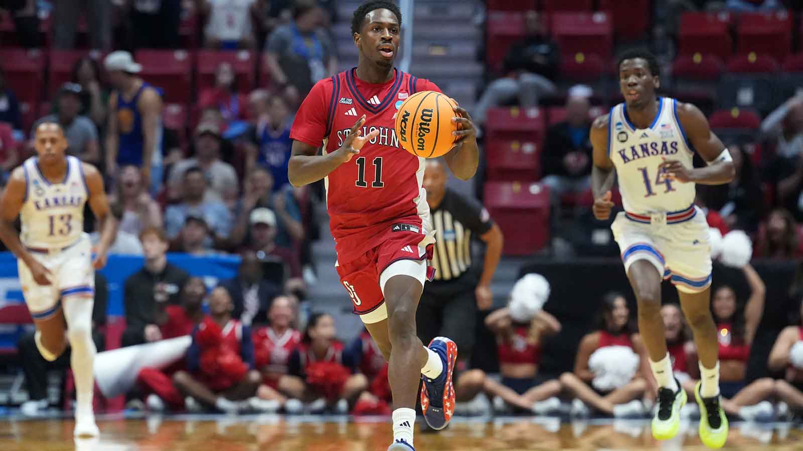 St. John's Red Storm guard Ian Jackson (11) controls the ball against the Kansas Jayhawks in the first half during a second round game of the men's 2026 NCAA Tournament at Viejas Arena.