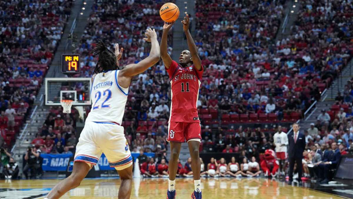 St. John's Red Storm guard Ian Jackson (11) shoots against Kansas Jayhawks guard Darryn Peterson (22) in the first half during a second round game of the men's 2026 NCAA Tournament at Viejas Arena.