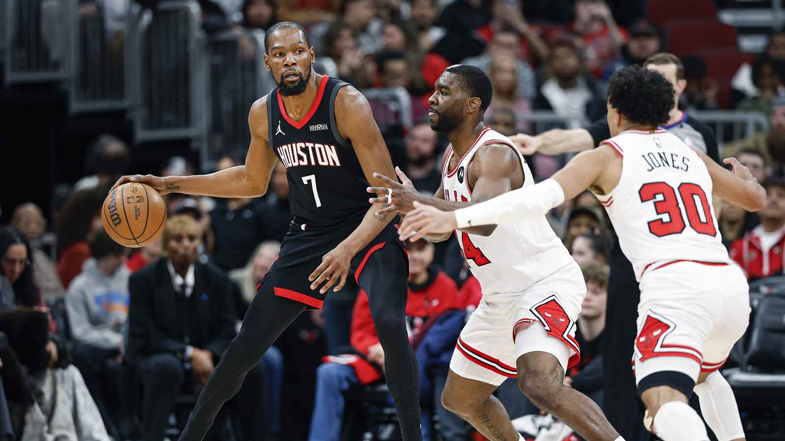 Chicago Bulls forward Patrick Williams (44) and guard Tre Jones (30) defend against Houston Rockets forward Kevin Durant (7) during the second half at United Center.