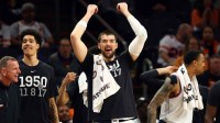 Los Angeles Clippers center Ivica Zubac celebrates with teammates on the bench against the Phoenix Suns in the second half at Mortgage Matchup Center. Mandatory Credit: Mark J. Rebilas-Imagn Images