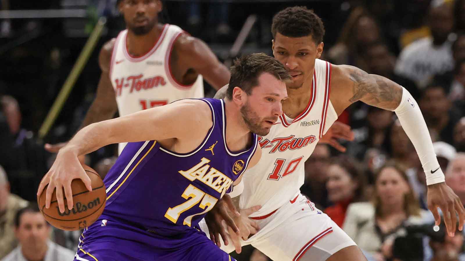 Los Angeles Lakers guard Luka Doncic (77) dribbles against Houston Rockets forward Jabari Smith Jr. (10) in the second quarter at Toyota Center.