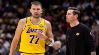Los Angeles Lakers forward/guard Luka Doncic (77) talks to Head Coach JJ Redick against the New Orleans Pelicans during the second half at Smoothie King Center.