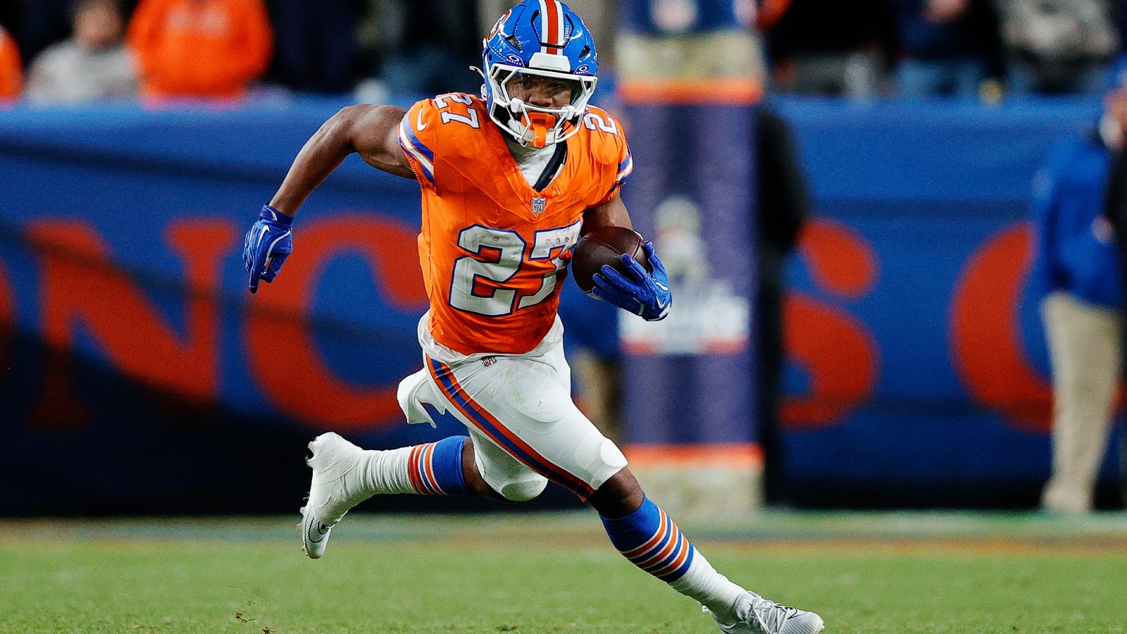 Denver Broncos running back J.K. Dobbins (27) runs the ball in the fourth quarter against the Las Vegas Raiders at Empower Field at Mile High.