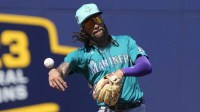 Seattle Mariners shortstop JP Crawford (3) flips the ball for an out against the Milwaukee Brewers in the third inning at American Family Fields of Phoenix.