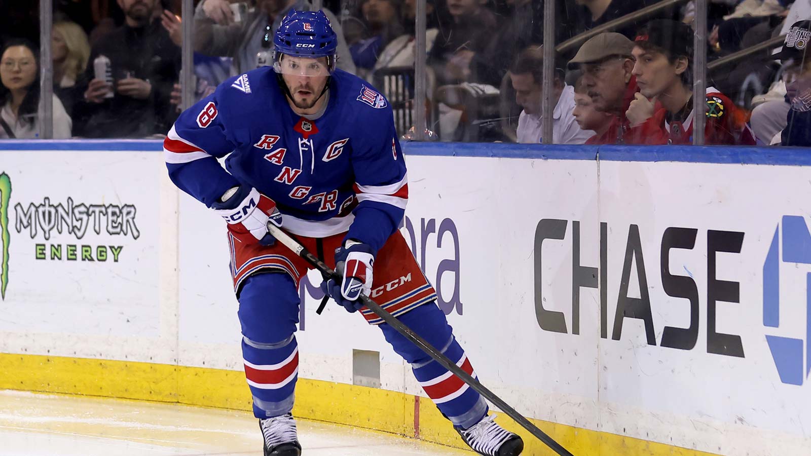 New York Rangers left wing J.T. Miller (8) skates with the puck against the Chicago Blackhawks during the second period at Madison Square Garden