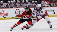 New Jersey Devils center Jack Hughes (86) skates with the puck while New York Rangers center Mika Zibanejad (93) defends during the second period at Prudential Center.