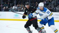 Seattle Kraken left wing Jaden Schwartz (17) and St. Louis Blues defenseman Matthew Kessel (51) battle for the puck in the second period at Climate Pledge Arena.