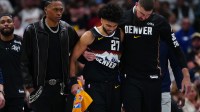 Denver Nuggets guard Jamal Murray (27) is helped off the court by guard Peyton Watson (8) and center Jonas Valanciunas (17) during the second quarter against the New York Knicks at Ball Arena.