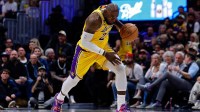 Los Angeles Lakers forward LeBron James (23) dribbles the ball up court in the third quarter against the Denver Nuggets at Ball Arena.