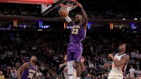 Los Angeles Lakers forward LeBron James (23) dunks against New York Knicks guard Josh Hart (3) and forward OG Anunoby (8) during the third quarter at Madison Square Garden