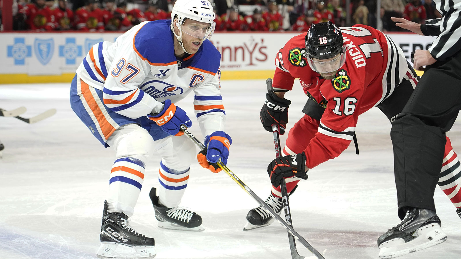 Edmonton Oilers center Connor McDavid (97) and Chicago Blackhawks center Jason Dickinson (16) go for the puck during the first period at United Center.