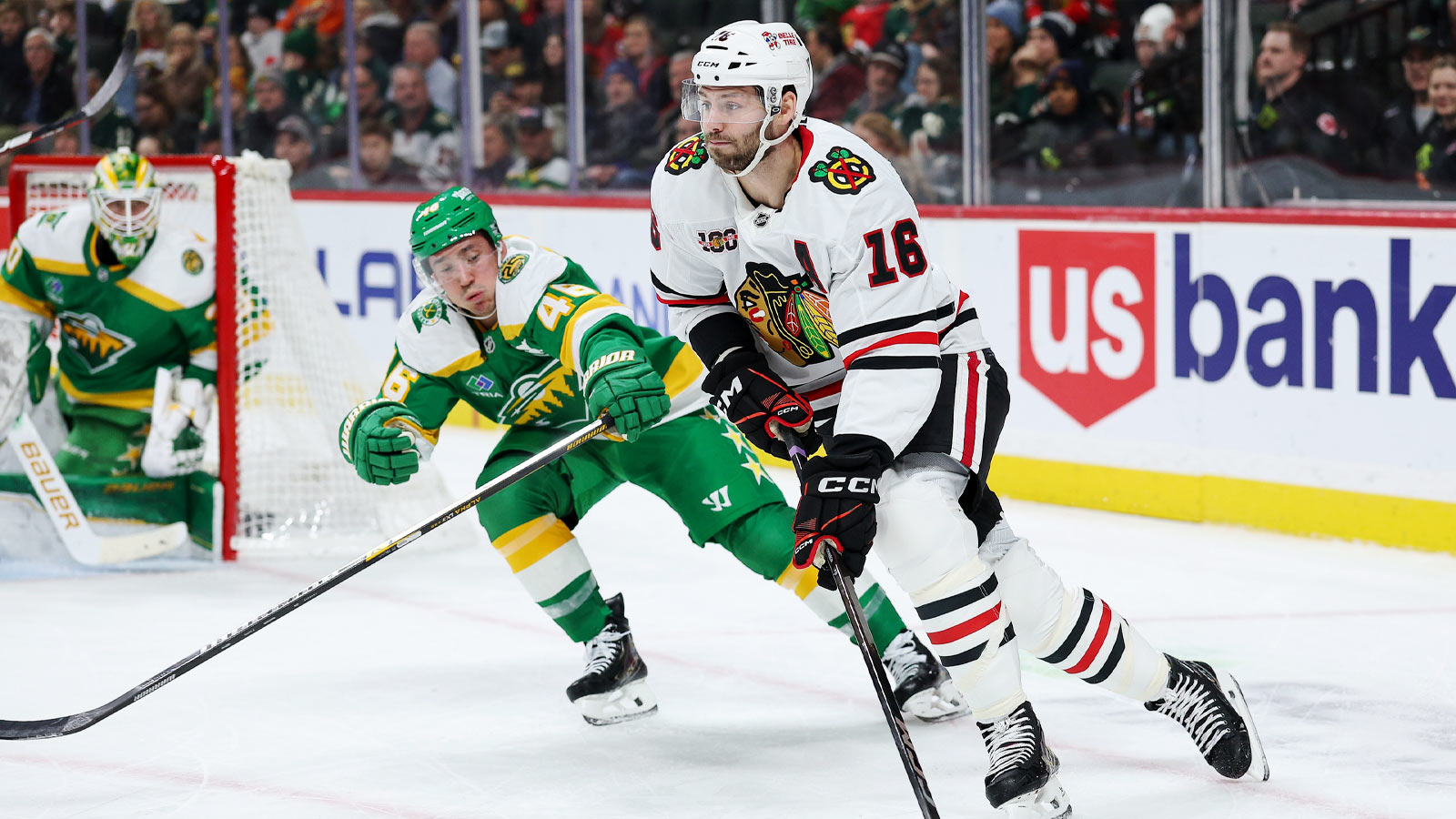 Chicago Blackhawks center Jason Dickinson (16) skates with the puck as Minnesota Wild defenseman Jared Spurgeon (46) defends during the first period at Grand Casino Arena.