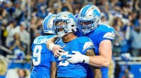 Detroit Lions running back David Montgomery (5) celebrates scoring a touchdown against Los Angeles Rams with center Frank Ragnow (77) during overtime at Ford Field in Detroit on Sunday, September 8, 2024.
