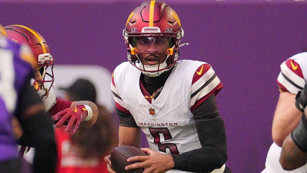 Washington Commanders quarterback Jayden Daniels (5) drops back to pass against the Minnesota Vikings during the first half at U.S. Bank Stadium.