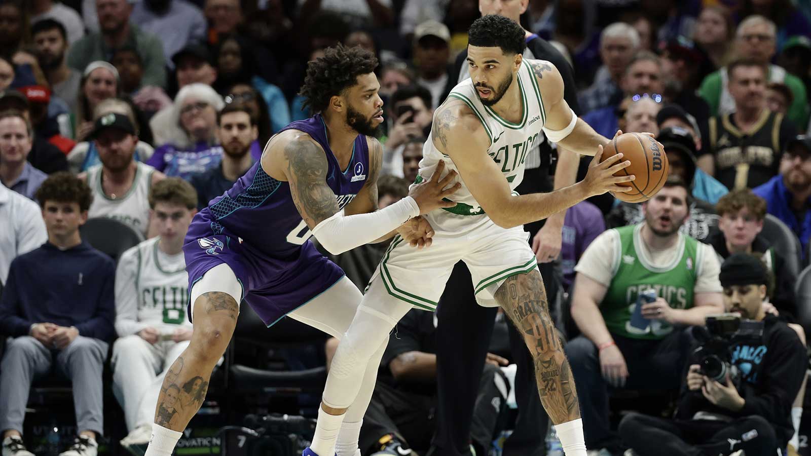 Boston Celtics forward/guard Jayson Tatum (0) is guarded by Charlotte Hornets forward Miles Bridges (0) during the second half at Spectrum Center.