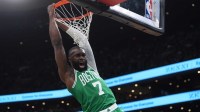 Boston Celtics guard Jaylen Brown (7) makes the basket against the Golden State Warriors in the first quarter at TD Garden.