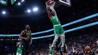 Boston Celtics guard Jaylen Brown (7) makes the basket against the Golden State Warriors in the first half at TD Garden.