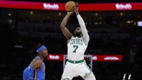 Celtics guard/forward Jaylen Brown (7) shoots over Thunder's Lu Dort