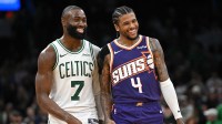 Phoenix Suns guard Jalen Green (4) and Boston Celtics guard Jaylen Brown (7) talk after a game at the TD Garden.