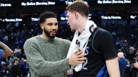 Dallas Mavericks forward Cooper Flagg (32) hugs Boston Celtics forward Jayson Tatum after the game at American Airlines Center.
