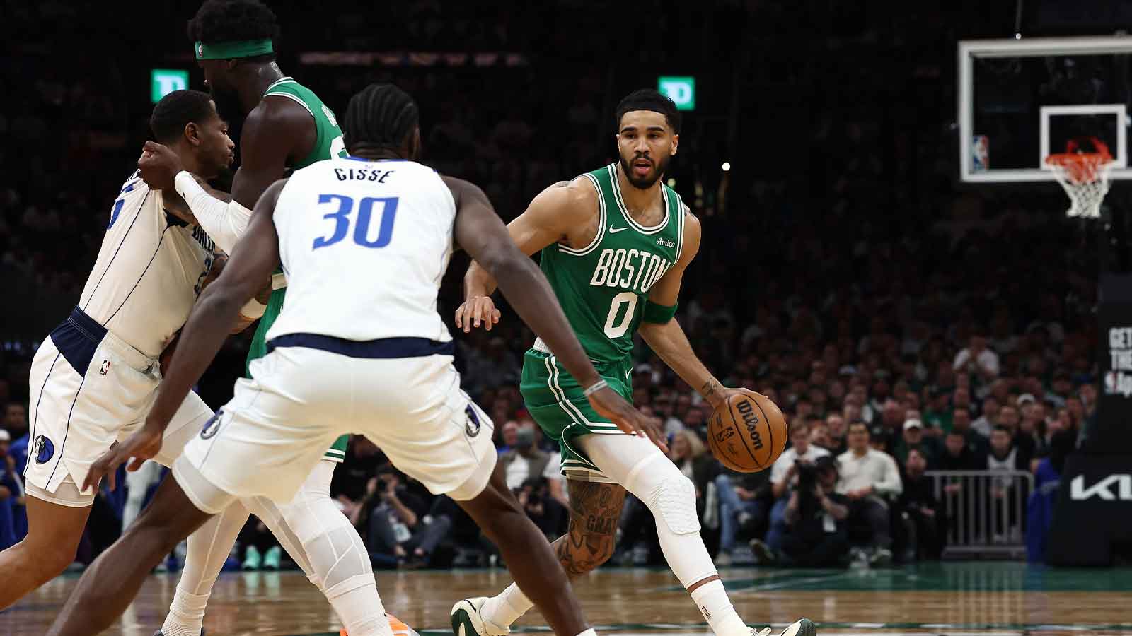 Boston Celtics forward Jayson Tatum (0) dribbles past a pick by center Neemias Queta (88) during the first quarter against the Dallas Mavericks at TD Garden.
