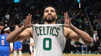 Boston Celtics forward Jayson Tatum (0) shows off his jersey before their game against the Oklahoma City Thunder at TD Garden.