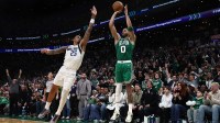 Boston Celtics forward Jayson Tatum (0) shoots past Dallas Mavericks forward P.J. Washington (25) during the second quarter at TD Garden.