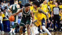Michigan State guard Jeremy Fears Jr. (1) dribbles against Michigan guard Elliot Cadeau (3) during the first half at Crisler Center in Ann Arbor on Sunday, March 8, 2026.