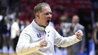 Utah State Aggies head coach Jerrod Calhoun celebrates after a first round game of the men's 2026 NCAA Tournament against the Villanova Wildcats at Viejas Arena.