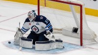 Winnipeg Jets goaltender Connor Hellebuyck (37) makes a save against the San Jose Sharks during the third period at SAP Center at San Jose.