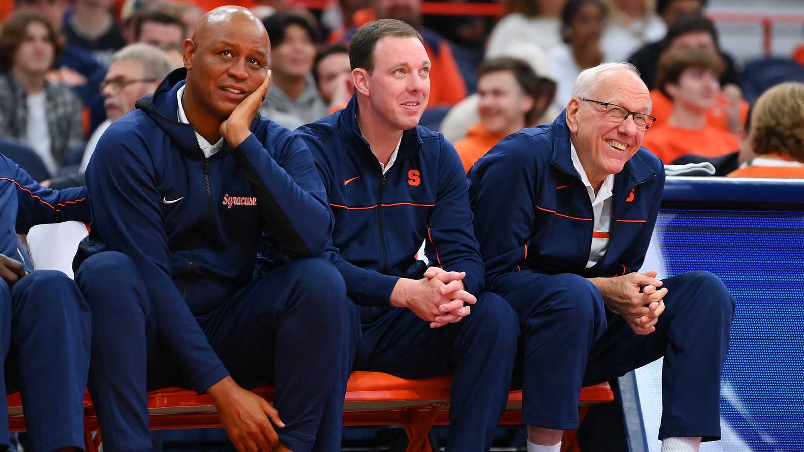 Syracuse Orange associate head coach Adrian Autry (left) and assistant coach Gerry McNamara (center) and head coach Jim Boeheim (right) watch the action at the Orange Tip Off at the JMA Wireless Dome.