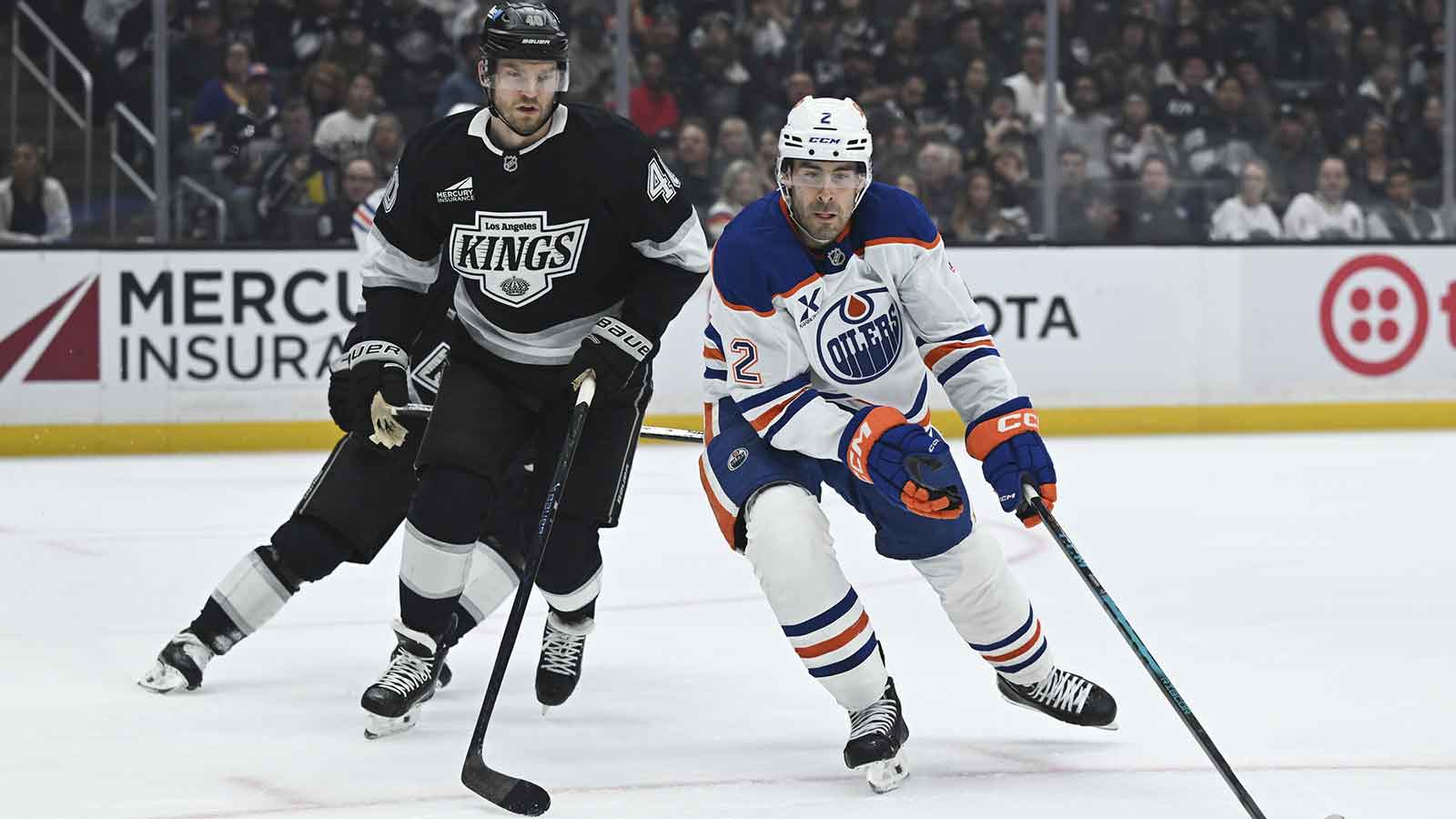 os Angeles Kings right wing Joel Armia (40) and Edmonton Oilers defenseman Evan Bouchard (2) battle for the puck during the first period at Crypto.com Arena.