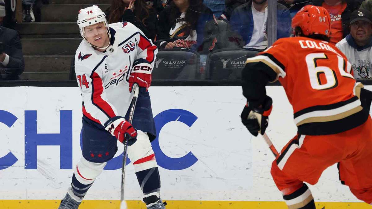 Mar 11, 2025; Anaheim, California, USA; Washington Capitals defenseman John Carlson (74) shoots against Anaheim Ducks right wing Sam Colangelo (64) during the first period at Honda Center.