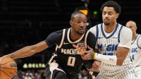 Atlanta Hawks forward Jonathan Kuminga (0) dribbles against Orlando Magic guard Jett Howard (13) during the second half at State Farm Arena.