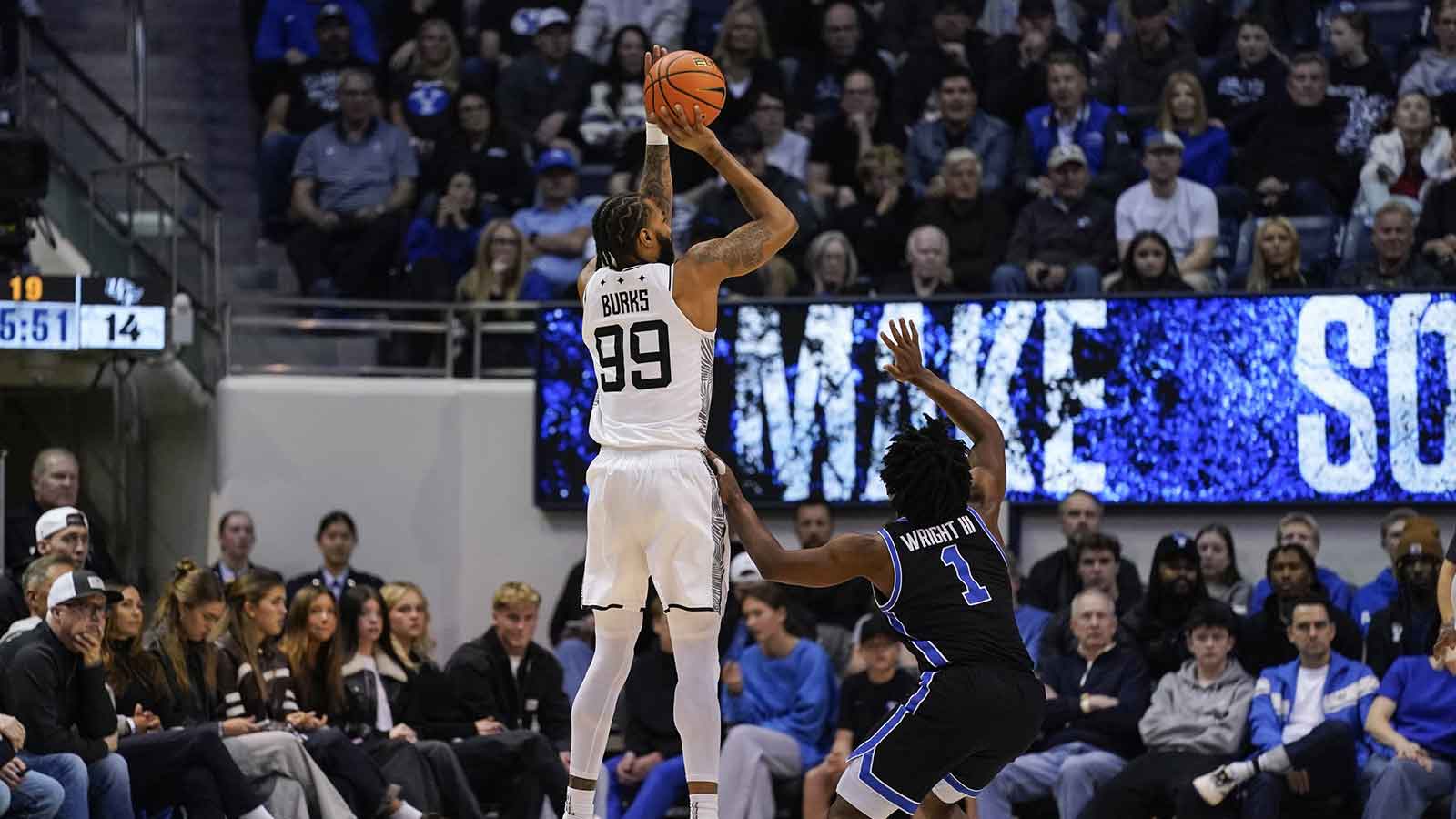 UCF Knights forward Jordan Burks (99) takes a three point shot during the first half against the BYU Cougars at Marriott Center.