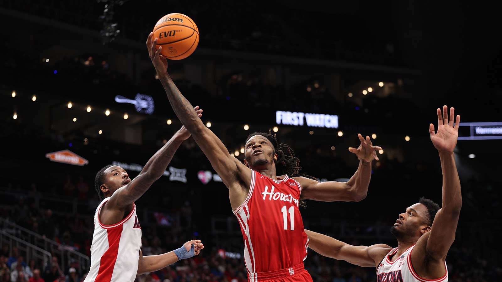 Houston Cougars forward Joseph Tugler (11) drives to the hoop past Arizona Wildcats forward Tobe Awaka (30) during the second half during the men's Big 12 Conference Tournament Championship at T-Mobile Center.