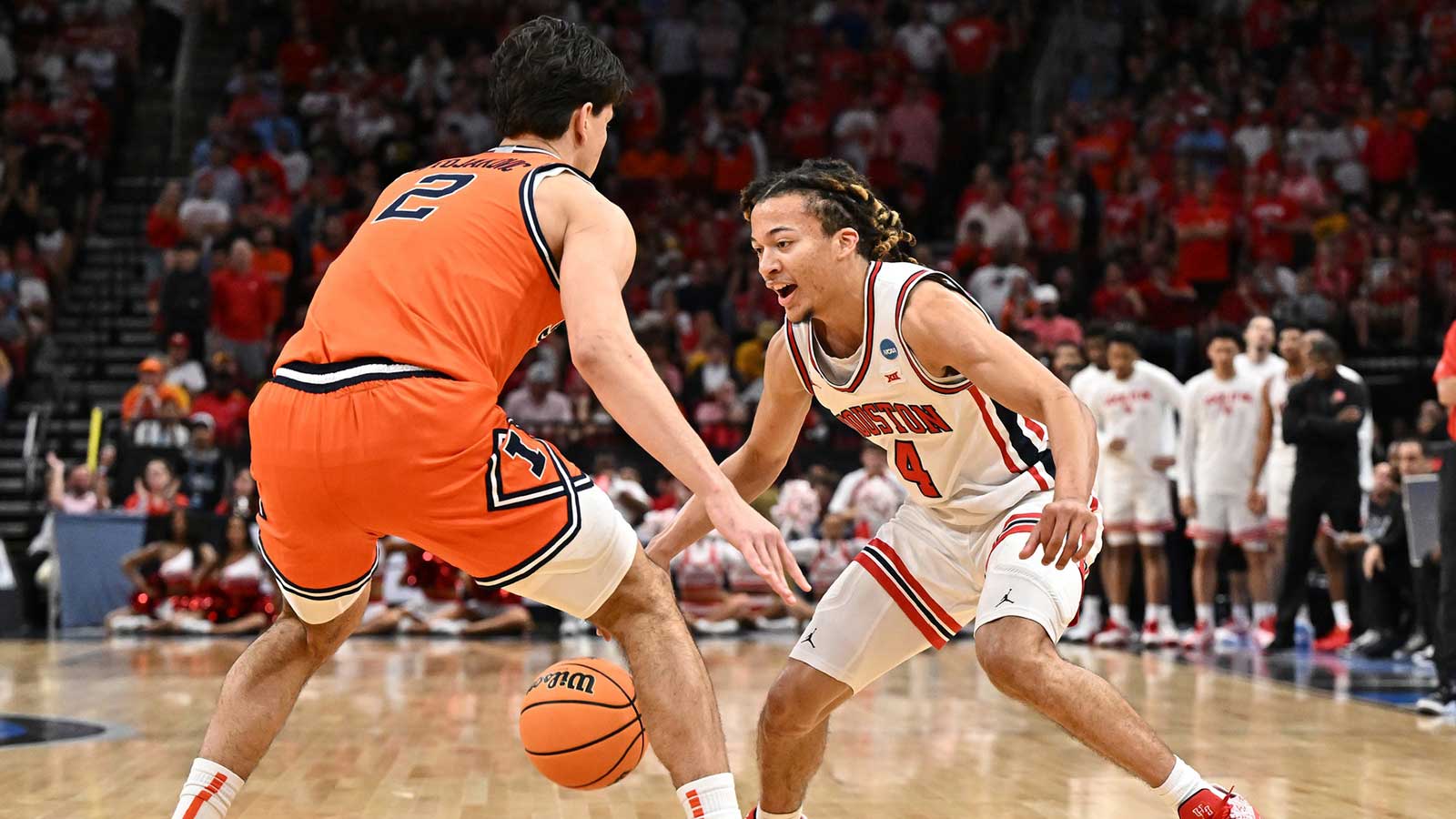 Houston Cougars guard Kingston Flemings (4) dribbles the ball against Illinois Fighting Illini guard Andrej Stojakovic (2) in the first half during a Sweet Sixteen game of the South Regional of the men's 2026 NCAA Tournament at Toyota Center.