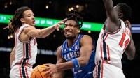 Kansas Jayhawks guard Darryn Peterson (22) drives to the basket between Houston Cougars guard Kingston Flemings (4) and Houston Cougars forward Kalifa Sakho (14) during the second half at T-Mobile Center.