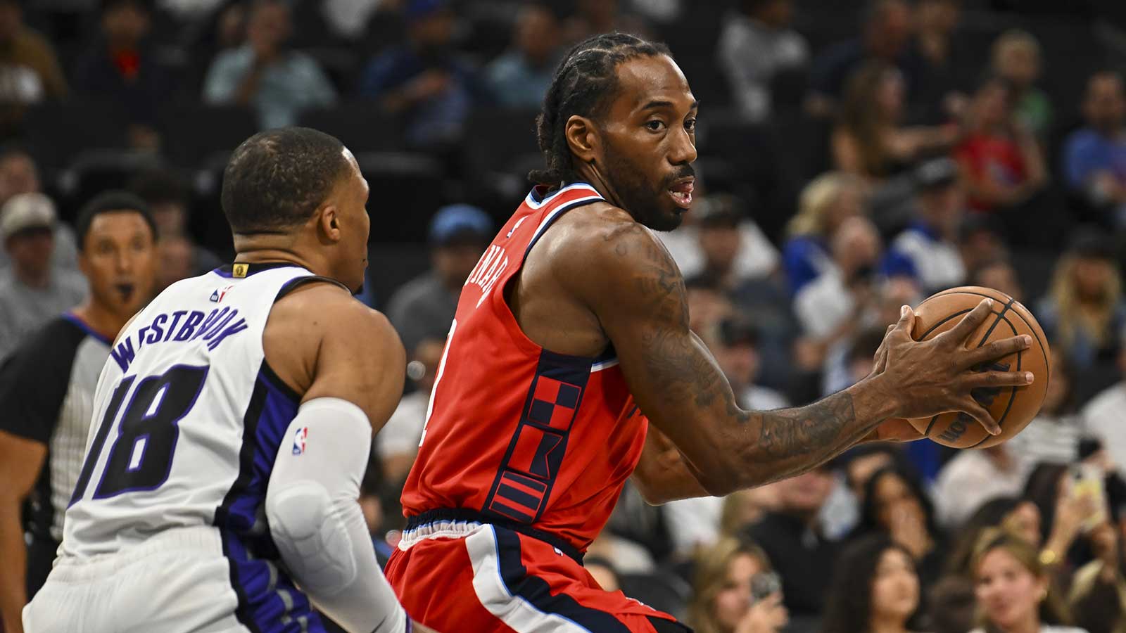 LA Clippers forward Kawhi Leonard (2) looks to pass against Sacramento Kings guard Russell Westbrook (18) during the first quarter at Intuit Dome.